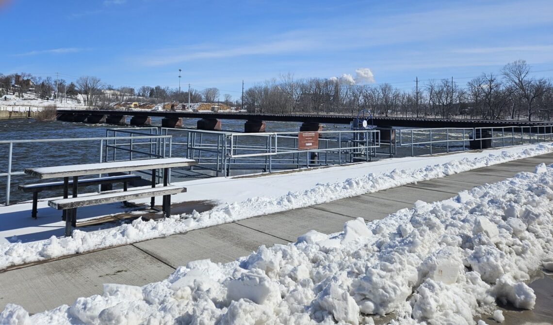 Picture of a picnic table next to a kayak boat launch in winter