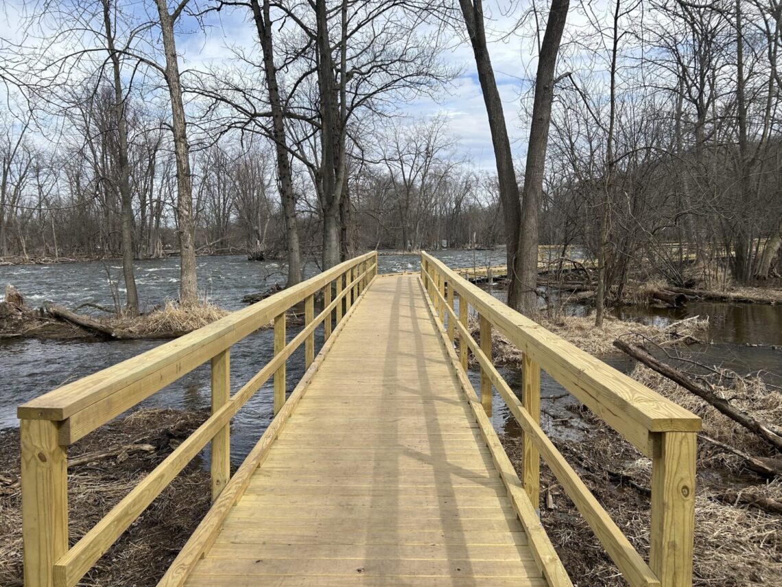 A picture of newly built wooden walkway with rails