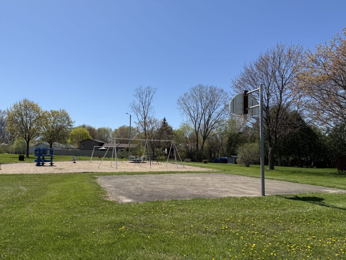 Picture of a half basketball court with sings in the background