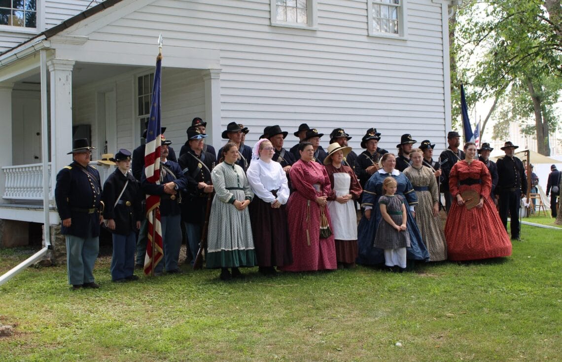 Civil War reenactors stand outside Grignon