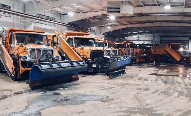 Picture of snow plows lined up in the garage