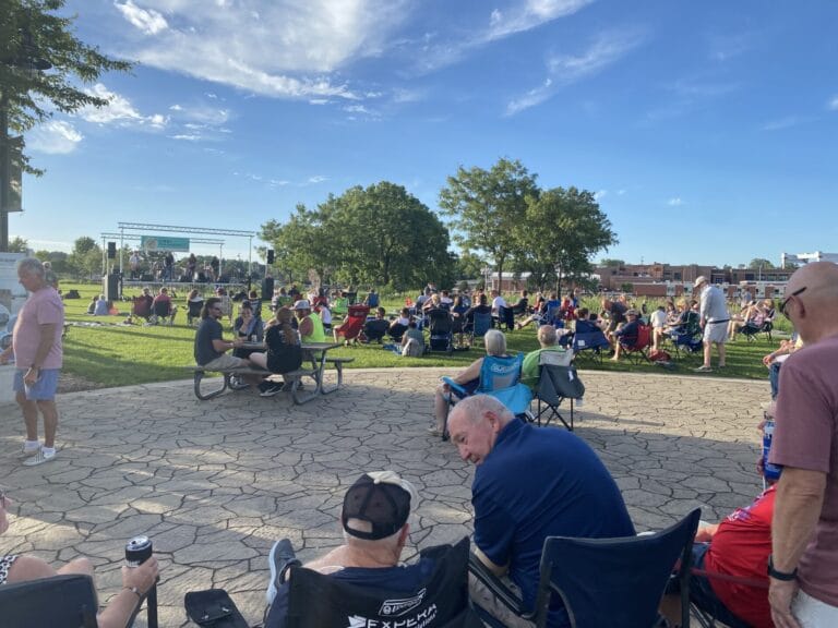 People sit at Hydro Park and listen to the Live! from Hydro Park Concert Series
