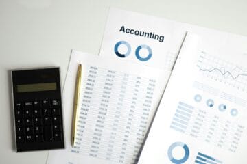 Stock image of calculator and accounting documents. Photo by Artem Podrez