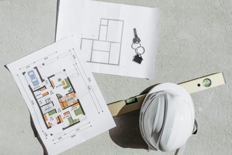 Stock image of house layout plans and a hard hat taken by Pavel Danilyuk.