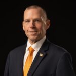 Man in suit smiling at camera