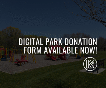 A playground with equipment is in a grassy area. Text overlay reads 